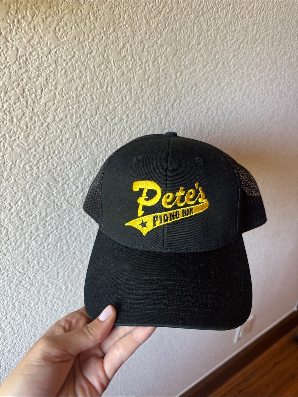 Pete's Piano Bar Black Trucker Hat with Yellow Logo